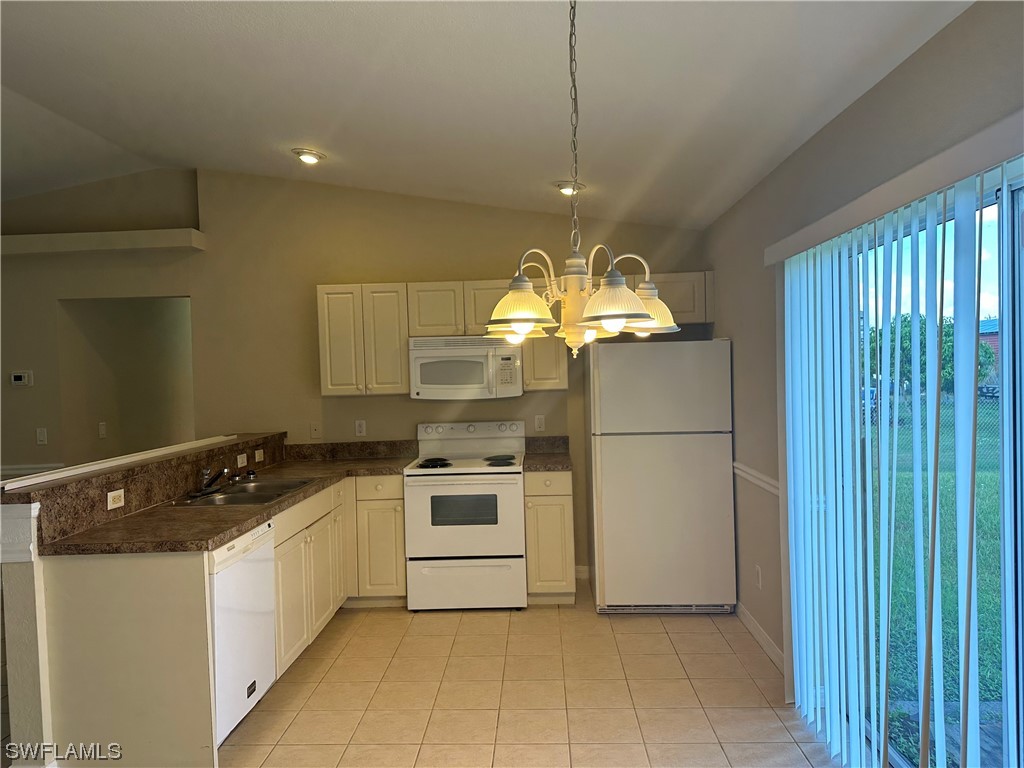 4106 24th Street Southwest Lehigh Acres, FL 33976 - Photo 4 of 15 a kitchen with stainless steel appliances granite countertop a sink a stove top oven and refrigerator