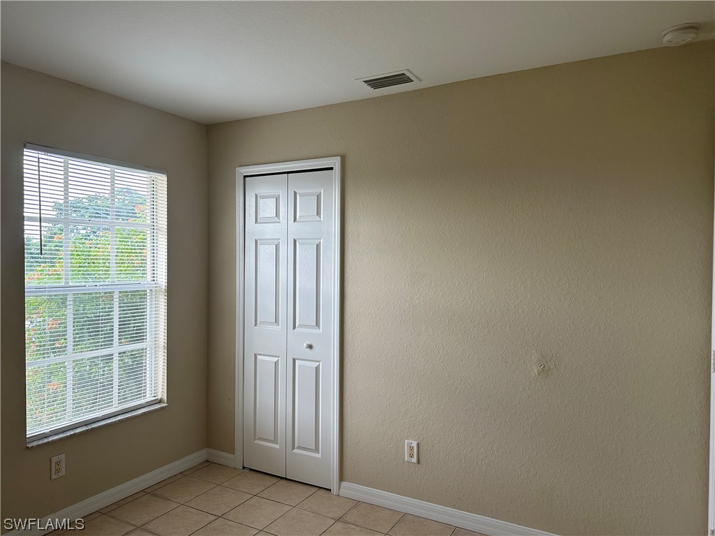 4106 24th Street Southwest Lehigh Acres, FL 33976 - Photo 7 of 15 an empty room with windows