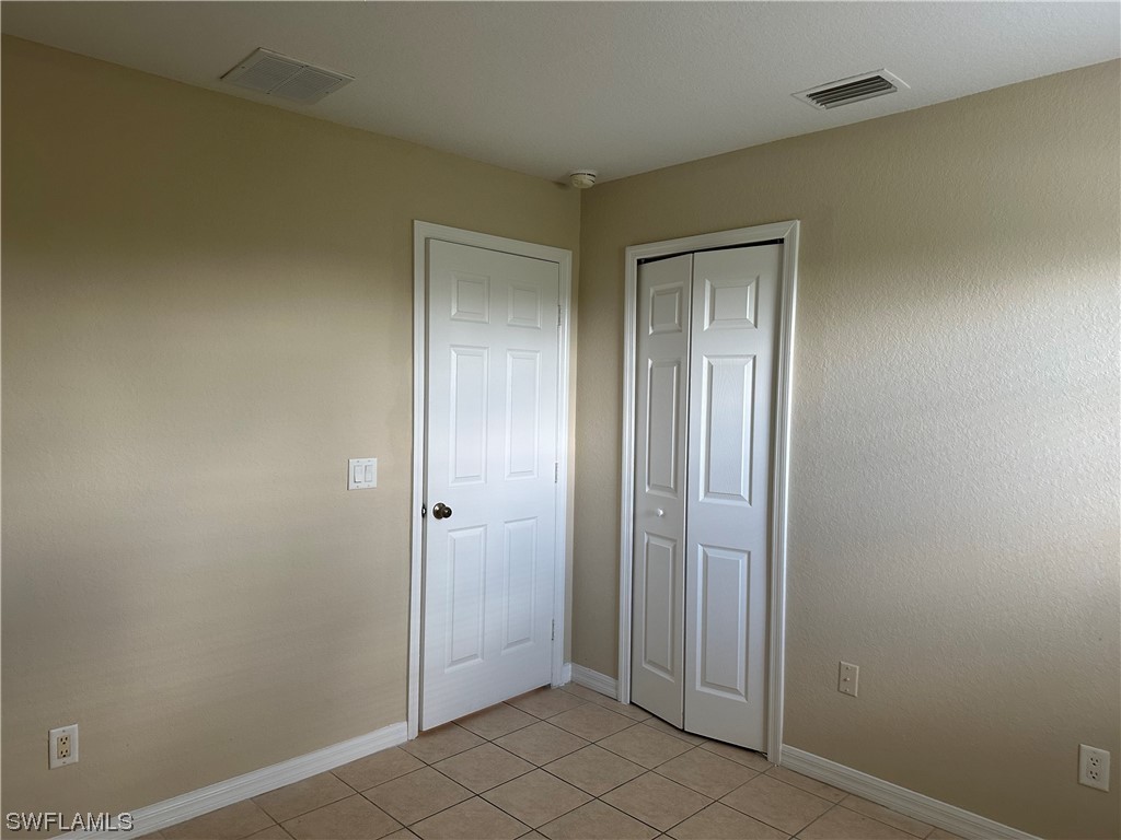 4106 24th Street Southwest Lehigh Acres, FL 33976 - Photo 10 of 15 an empty room that has a glass door and shower