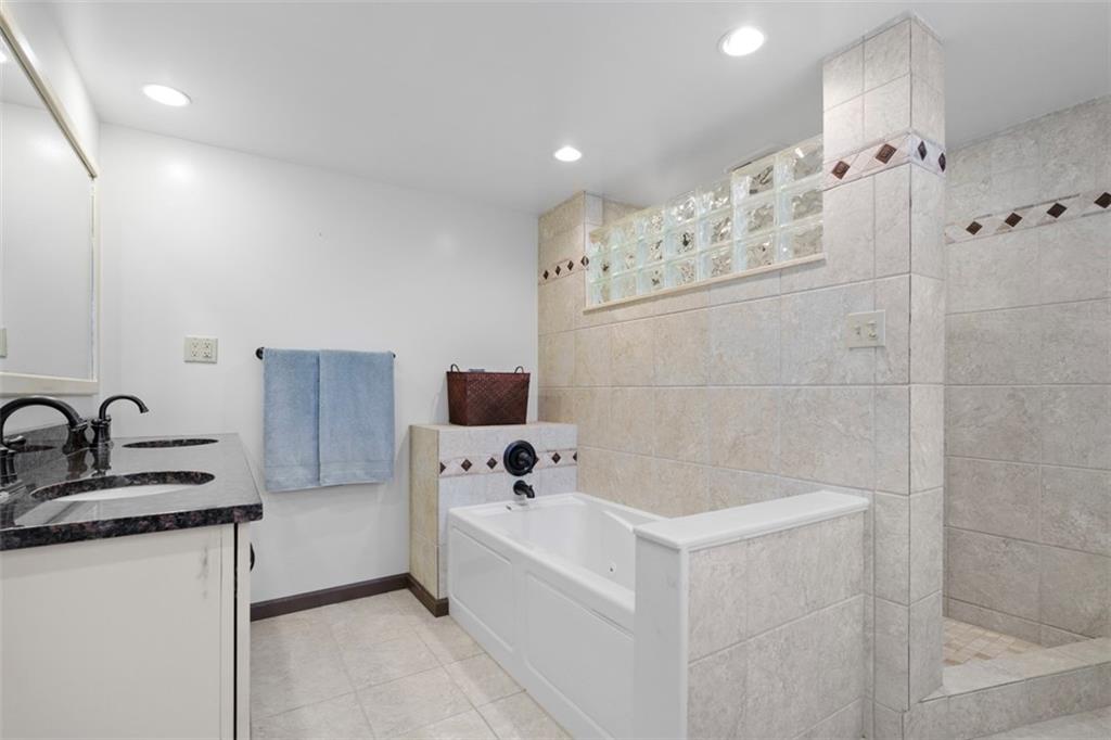 4 Cheryl Drive Coraopolis, PA 15108 - Photo 22 of 32 a bathroom with a bathtub sink and mirror