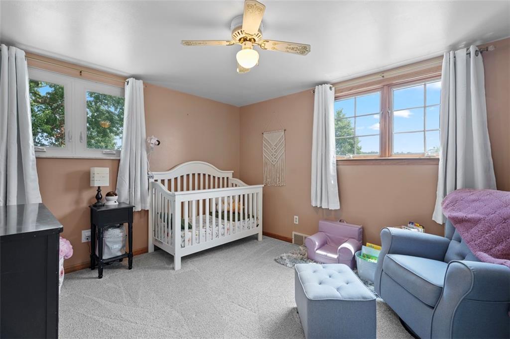 4 Cheryl Drive Coraopolis, PA 15108 - Photo 24 of 32 a bedroom with a bed and a chandelier