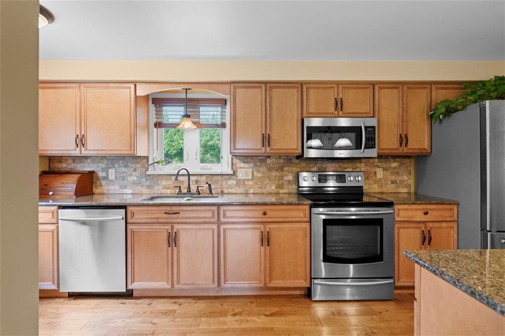 4 Cheryl Drive Coraopolis, PA 15108 - Photo 6 of 32 a kitchen with stainless steel appliances granite countertop a stove a sink and a microwave