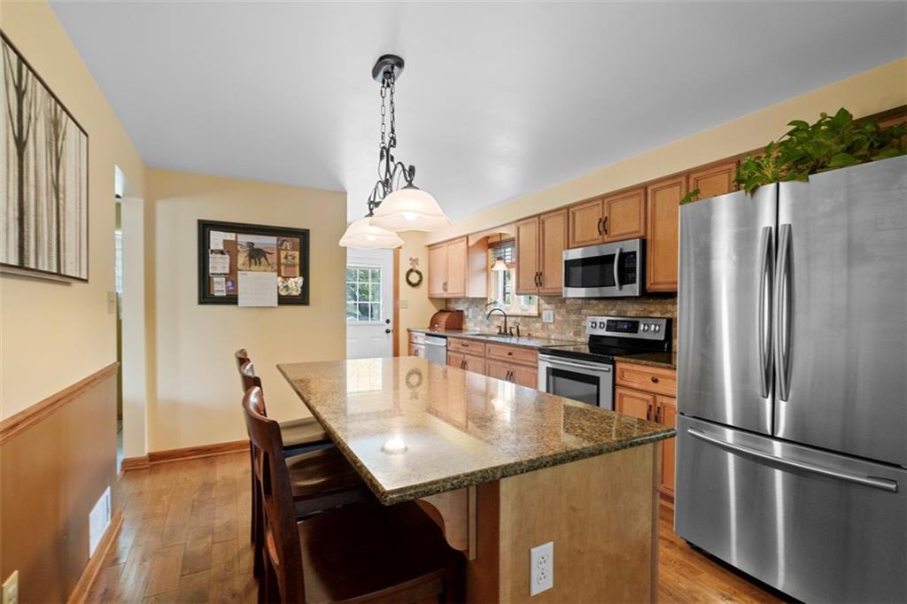 4 Cheryl Drive Coraopolis, PA 15108 - Photo 7 of 32 a kitchen with stainless steel appliances granite countertop a sink refrigerator and microwave