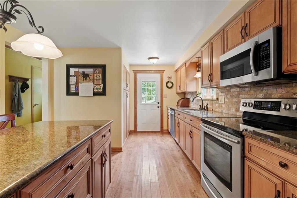 4 Cheryl Drive Coraopolis, PA 15108 - Photo 8 of 32 a large kitchen with stainless steel appliances granite countertop a stove and a sink
