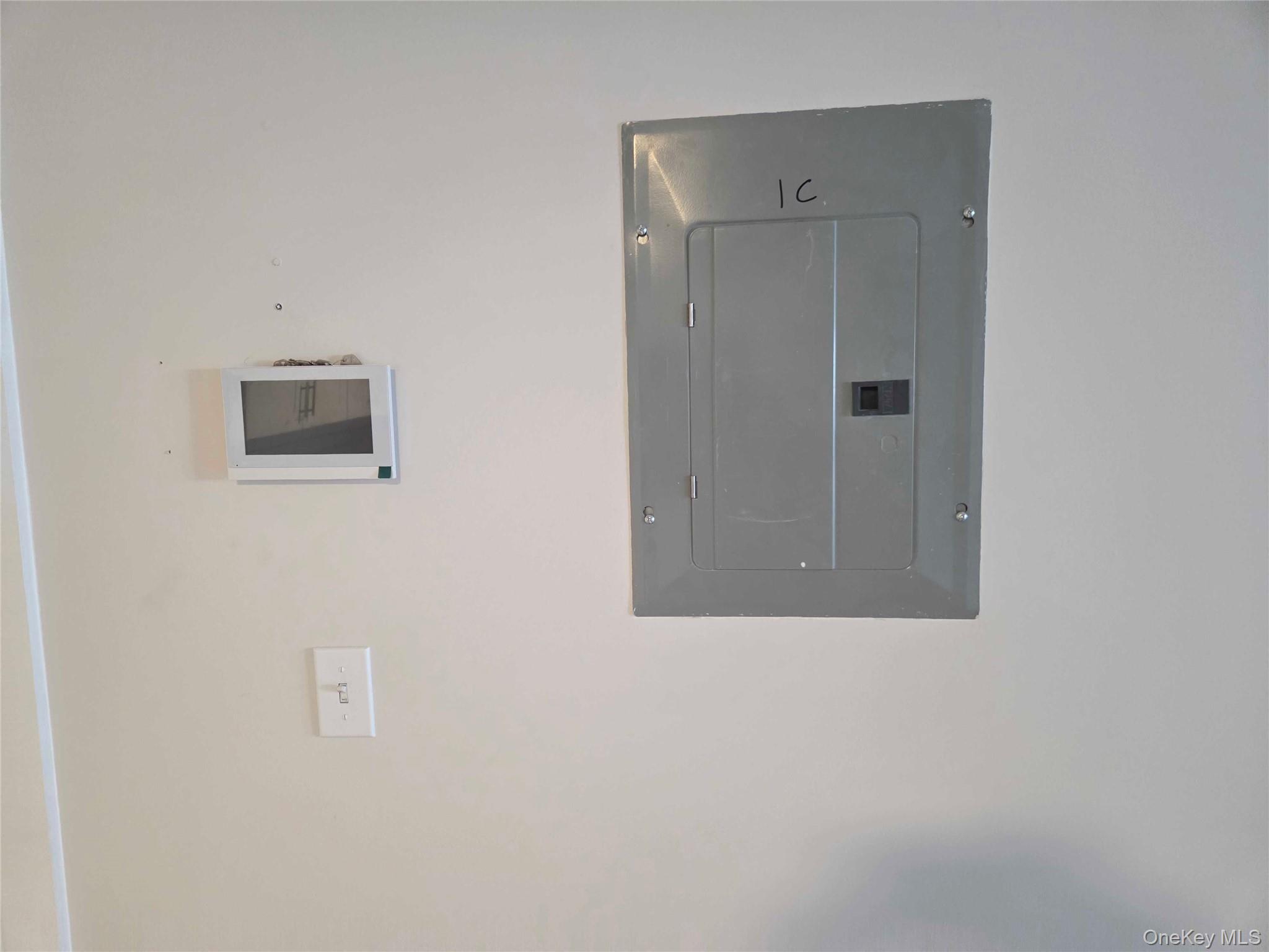 539 Front Street, Unit 4C Hempstead, NY 11550 - Photo 12 of 17 Utility room featuring electric panel