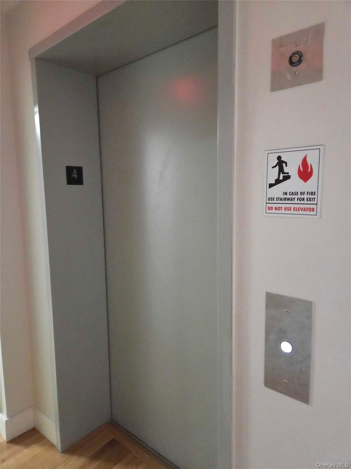 539 Front Street, Unit 4C Hempstead, NY 11550 - Photo 15 of 17 Detailed view of elevator and wood finished floors