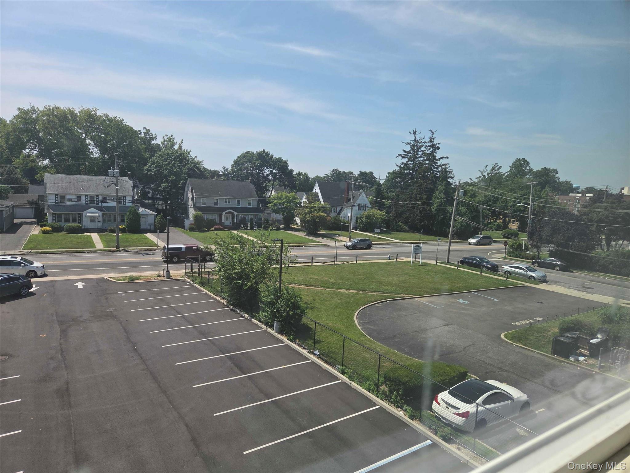 539 Front Street, Unit 4C Hempstead, NY 11550 - Photo 16 of 17 Uncovered parking lot with a residential view