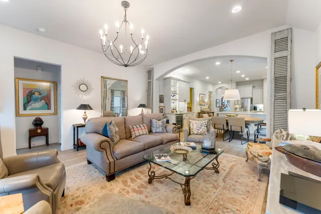 a living room with fireplace furniture and a chandelier