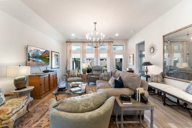 a living room with furniture and a chandelier