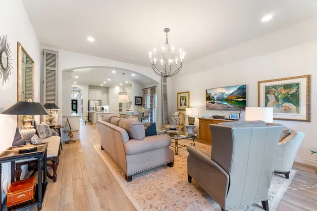 a living room with fireplace furniture and a chandelier