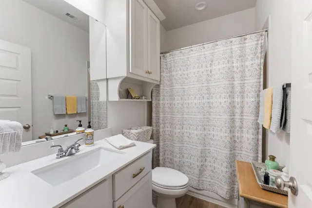 a bathroom with a sink toilet and shower