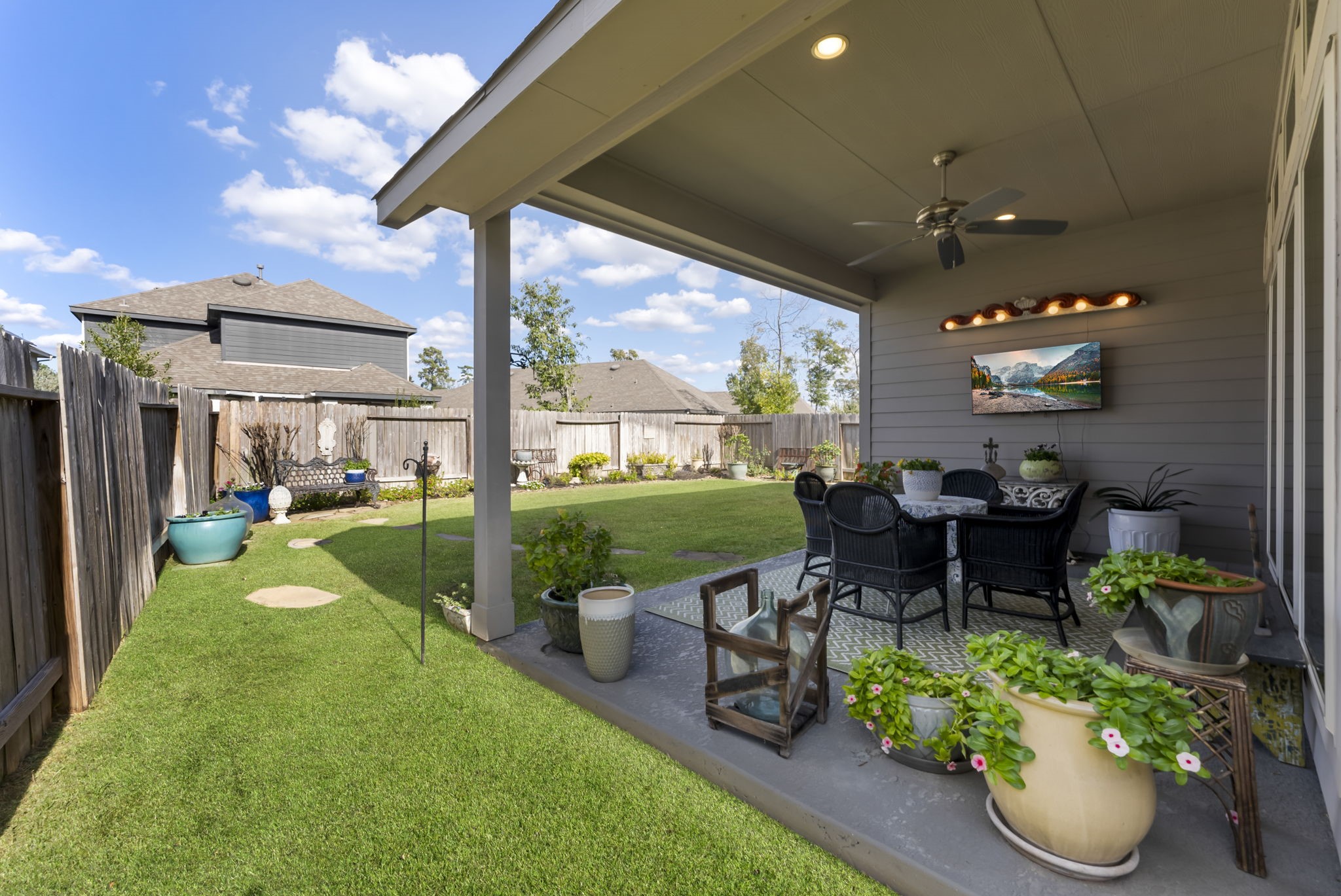 545 Cedar Harbor Court Conroe, TX 77304 - Photo 41 of 50 a view of a patio with chairs potted plants with large tree
