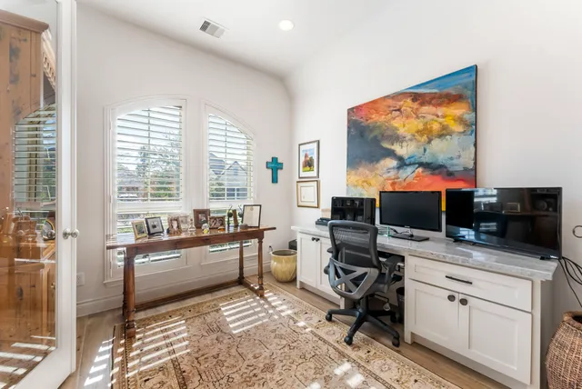 a room with furniture a flat screen tv and a floor to ceiling window