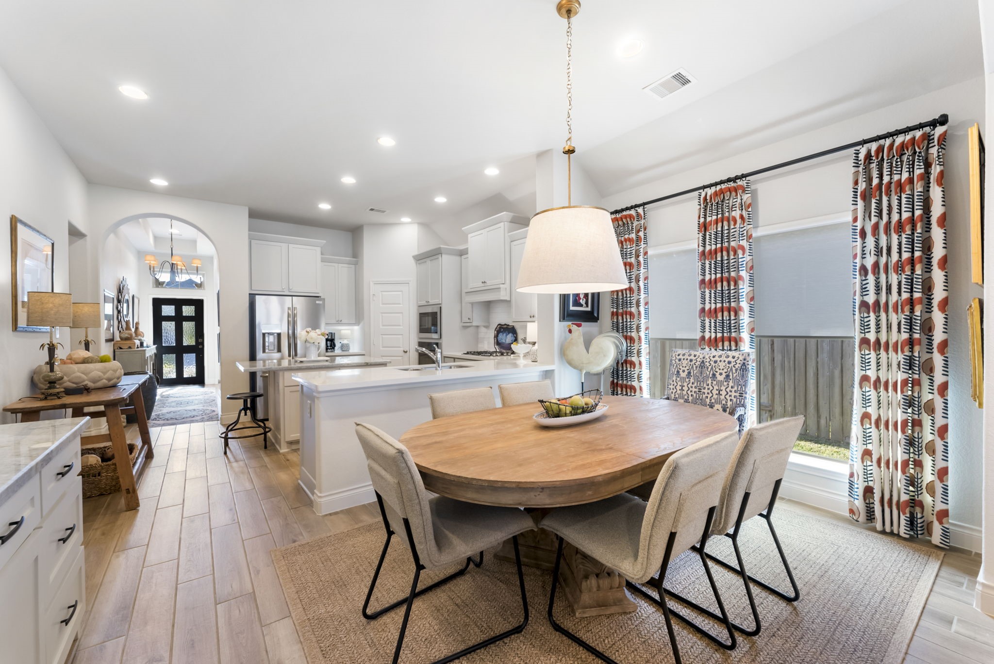 545 Cedar Harbor Court Conroe, TX 77304 - Photo 8 of 50 a view of a dining room and livingroom with furniture wooden floor a chandelier