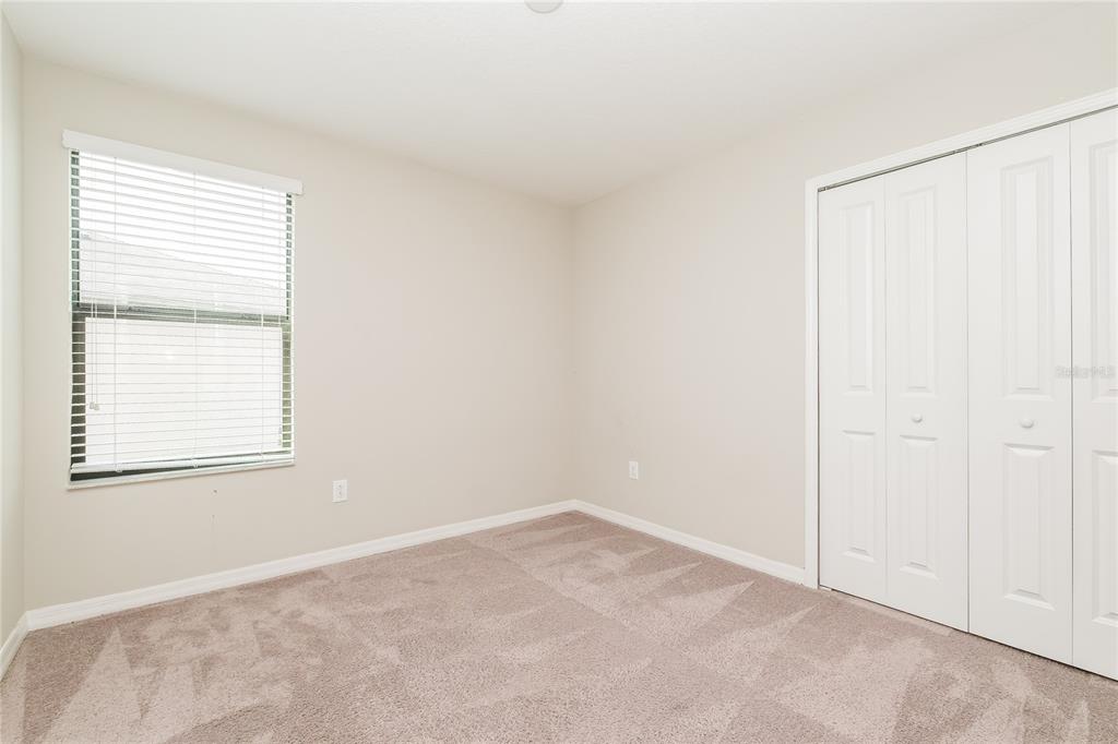 36125 Stable Wilk Avenue Zephyrhills, FL 33541 - Photo 10 of 17 an empty room with a window