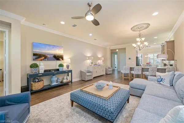 a living room with furniture and a chandelier