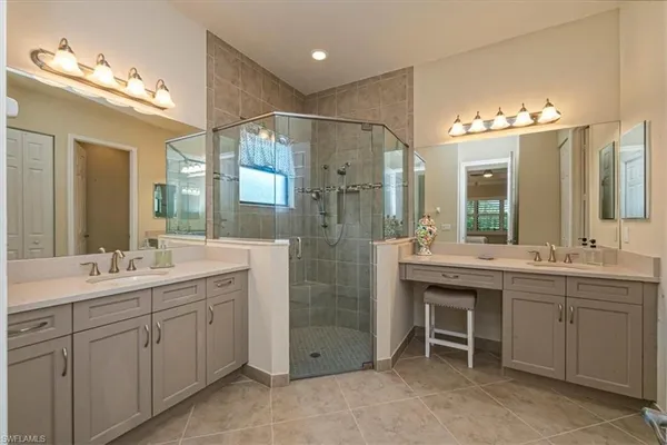 a bathroom with a double vanity sink mirror and double