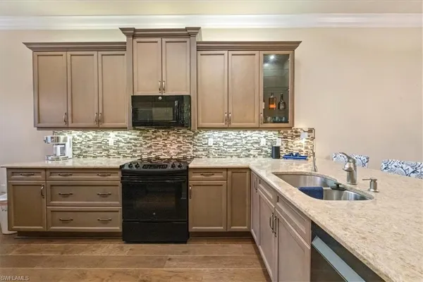 a kitchen with granite countertop a sink and cabinets