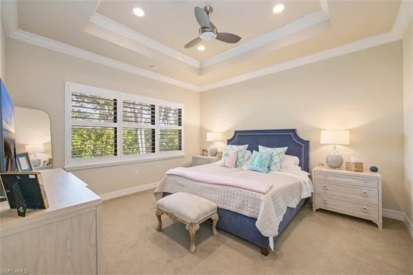 a bedroom with a large bed and a large window