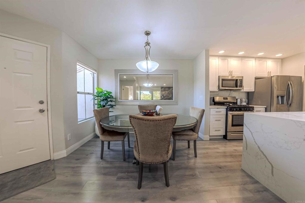 a view of a dining room with furniture and chandelier