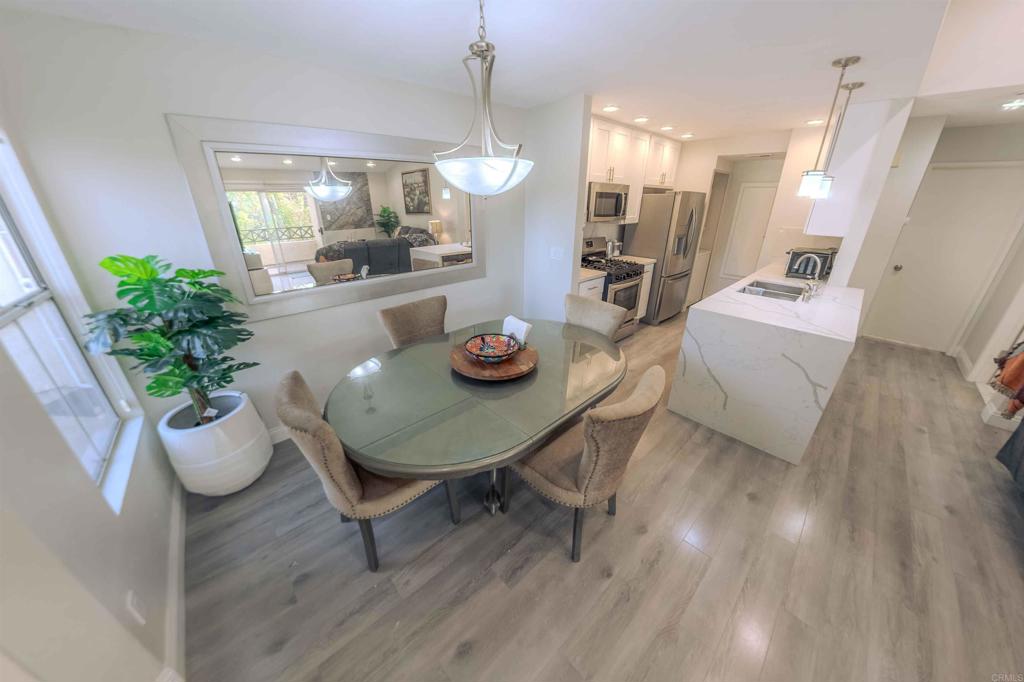 767 Brookstone Road, Unit 301 Chula Vista, CA 91913 - Photo 12 of 28 a view of a dining room and livingroom with furniture wooden floor and a chandelier