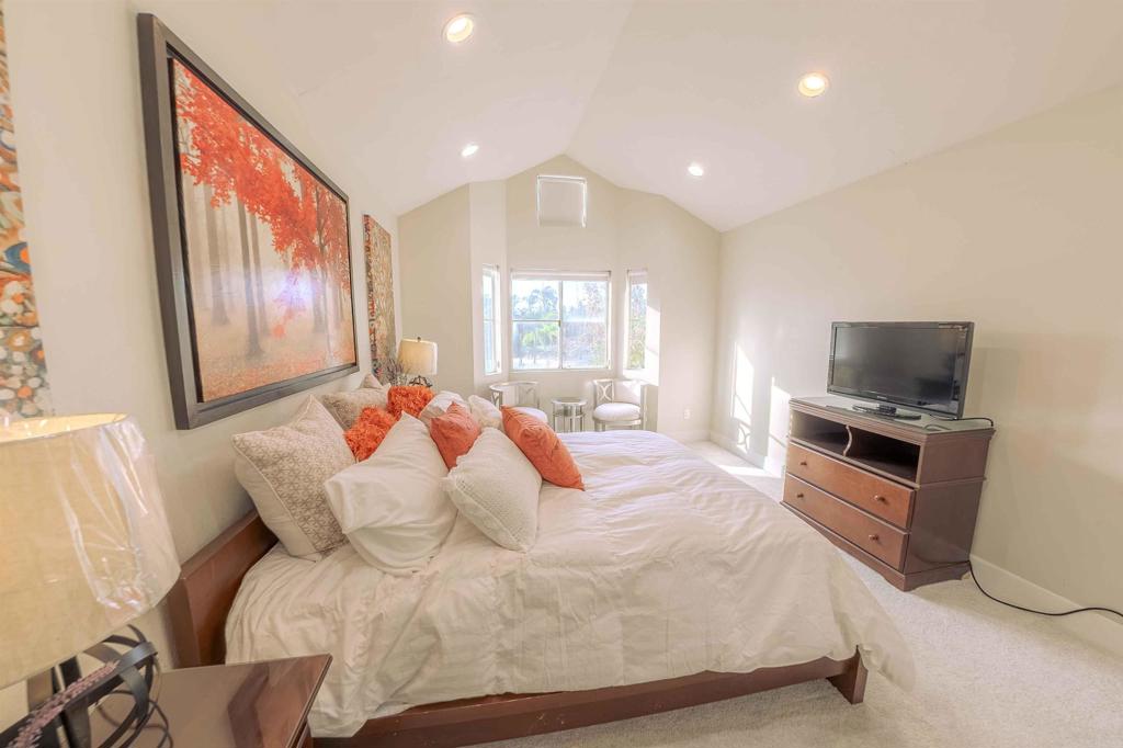 767 Brookstone Road, Unit 301 Chula Vista, CA 91913 - Photo 13 of 28 a large bedroom with a bed and a large window