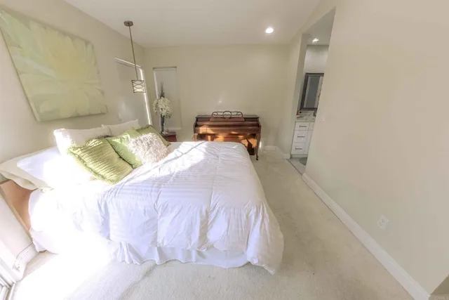 a spacious bedroom with a bed and a window