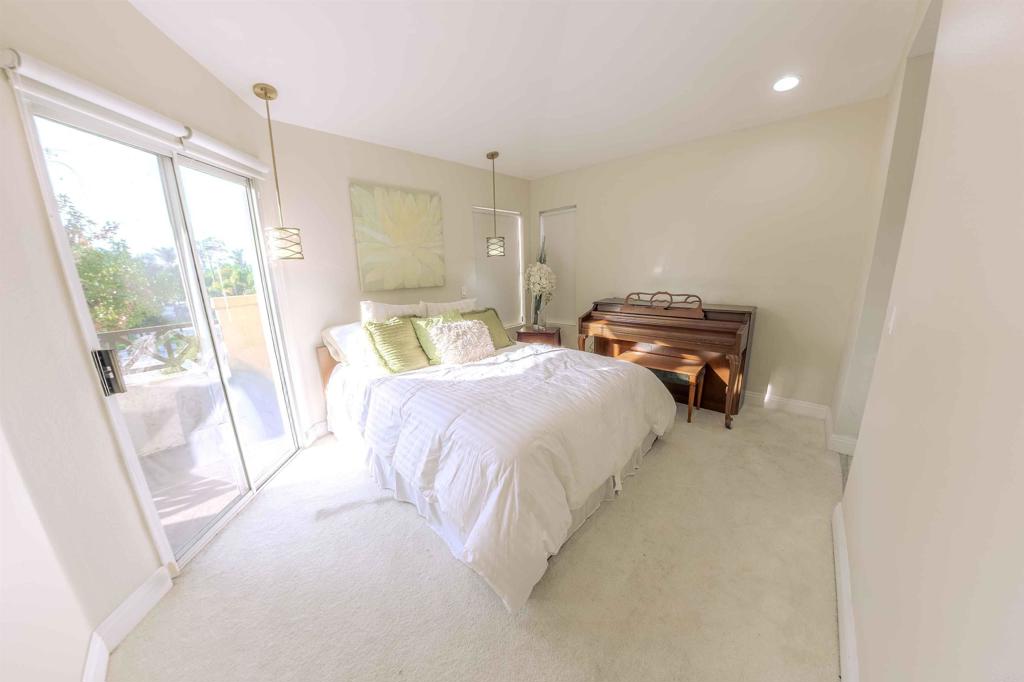 767 Brookstone Road, Unit 301 Chula Vista, CA 91913 - Photo 22 of 28 a bedroom with a bed and wooden floor