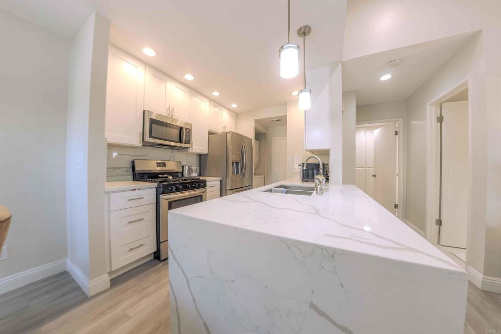 767 Brookstone Road, Unit 301 Chula Vista, CA 91913 - Photo 28 of 28 a open kitchen with kitchen island a sink stainless steel appliances and cabinets
