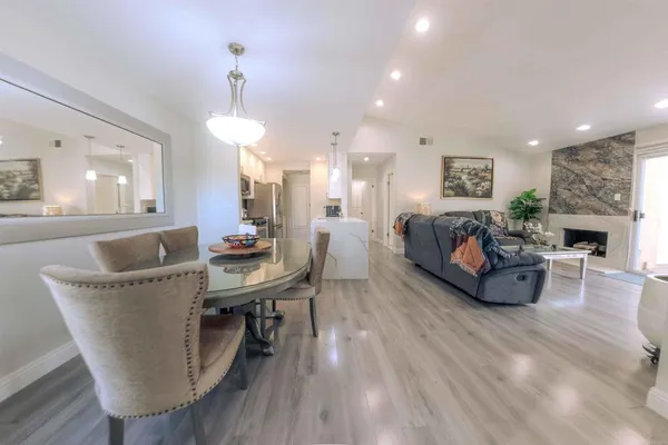 a living room with furniture a fireplace and a chandelier