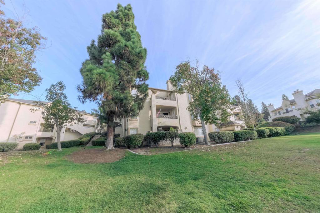 767 Brookstone Road, Unit 301 Chula Vista, CA 91913 - Photo 5 of 28 a view of a backyard with potted plants and large trees