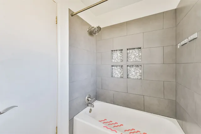 a bathroom with a bathtub and shower