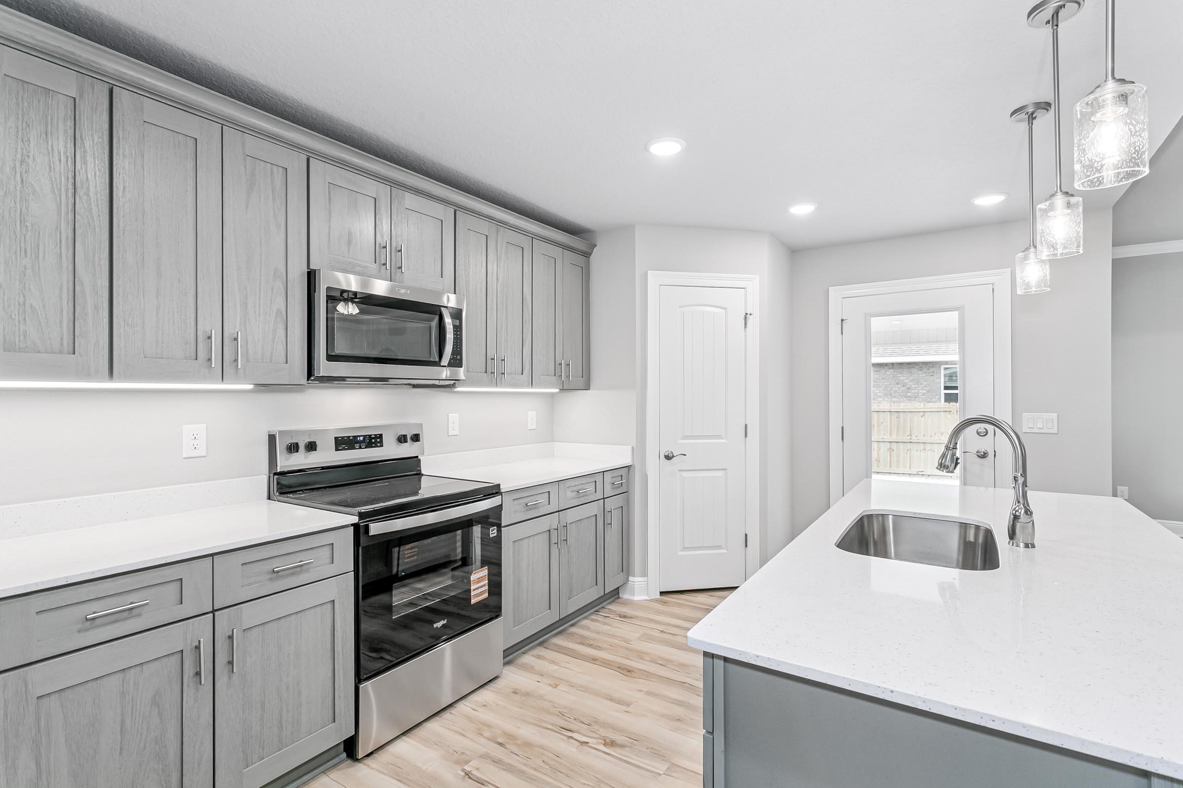 4823 Horace Lunsford Road Milton, FL 32570 - Photo 13 of 34 a kitchen with appliances a sink and cabinets