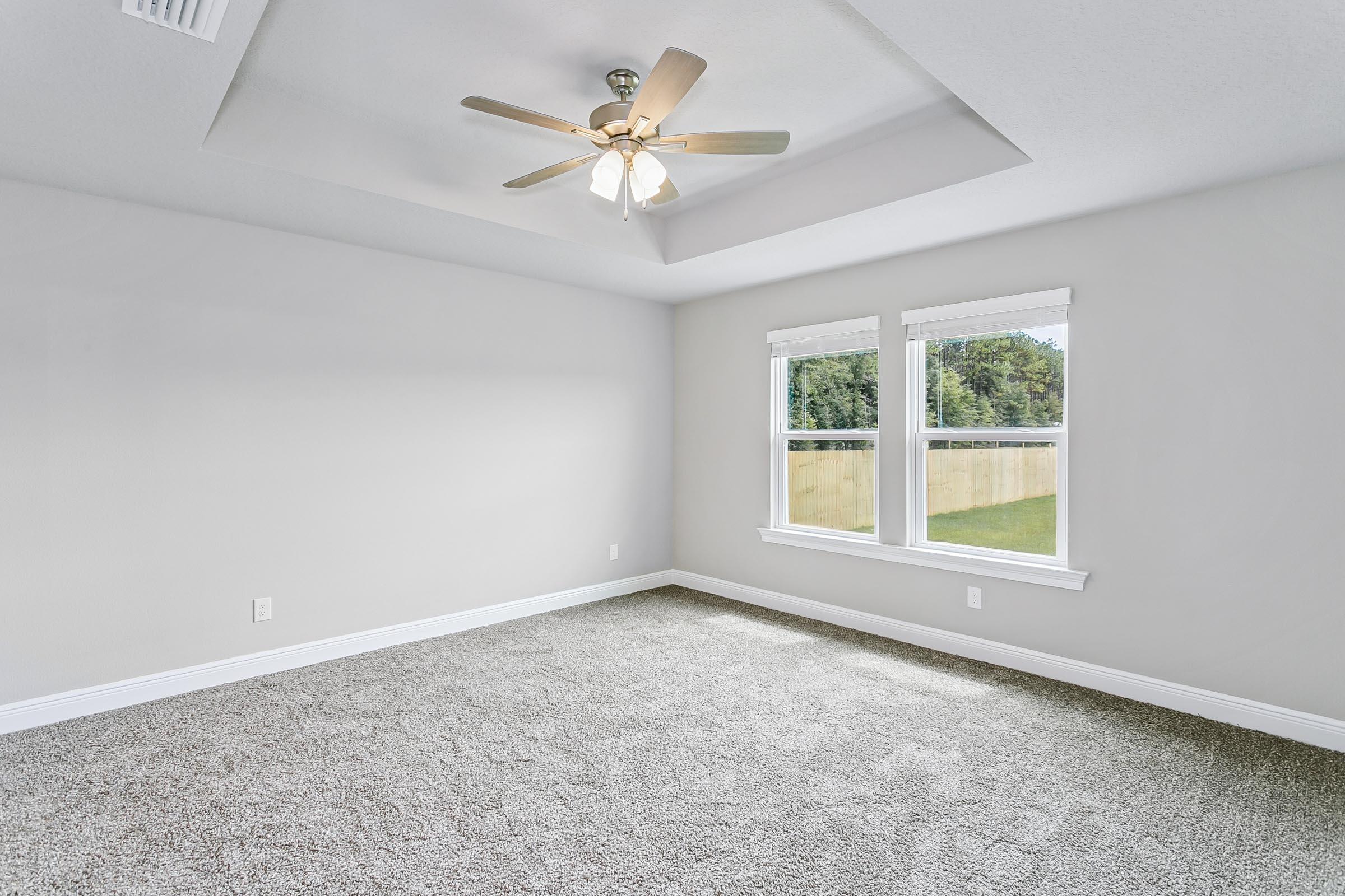 4823 Horace Lunsford Road Milton, FL 32570 - Photo 16 of 34 an empty room with windows and ceiling fan