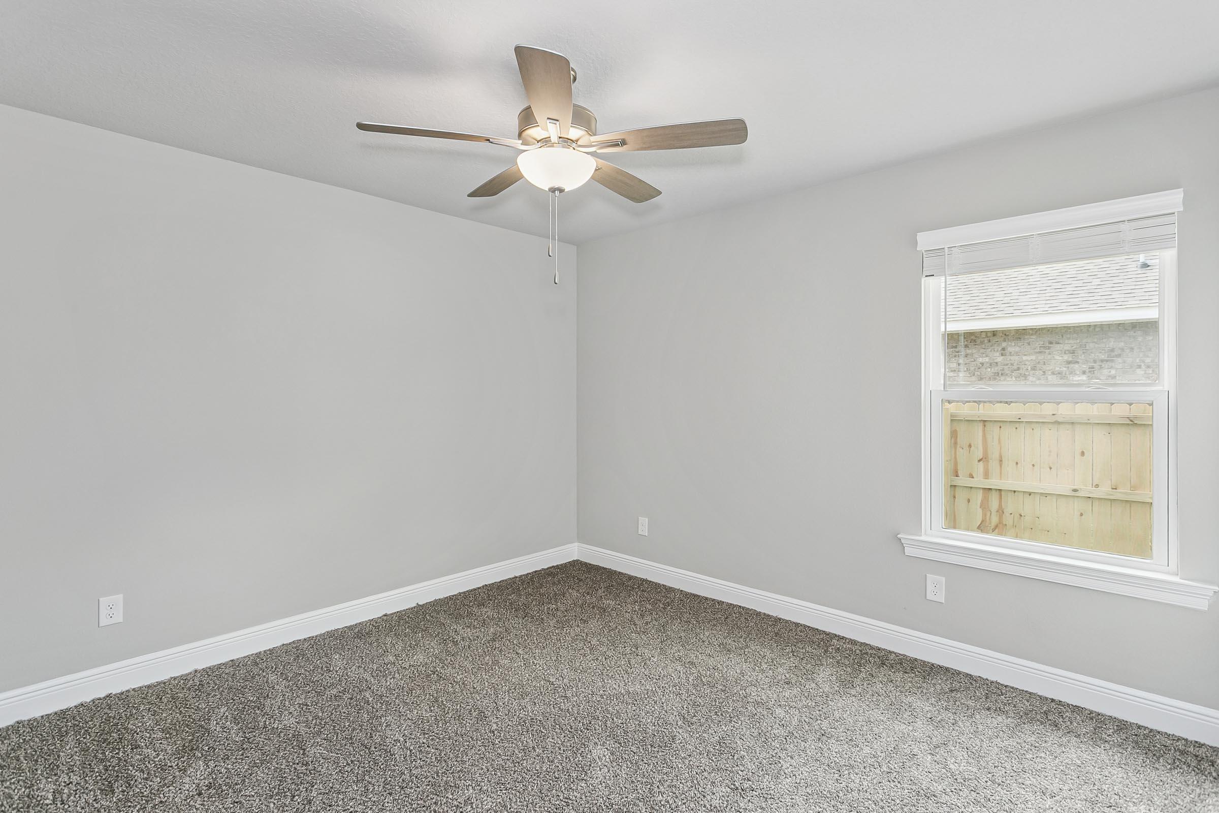 4823 Horace Lunsford Road Milton, FL 32570 - Photo 25 of 34 an empty room with a window and a fan