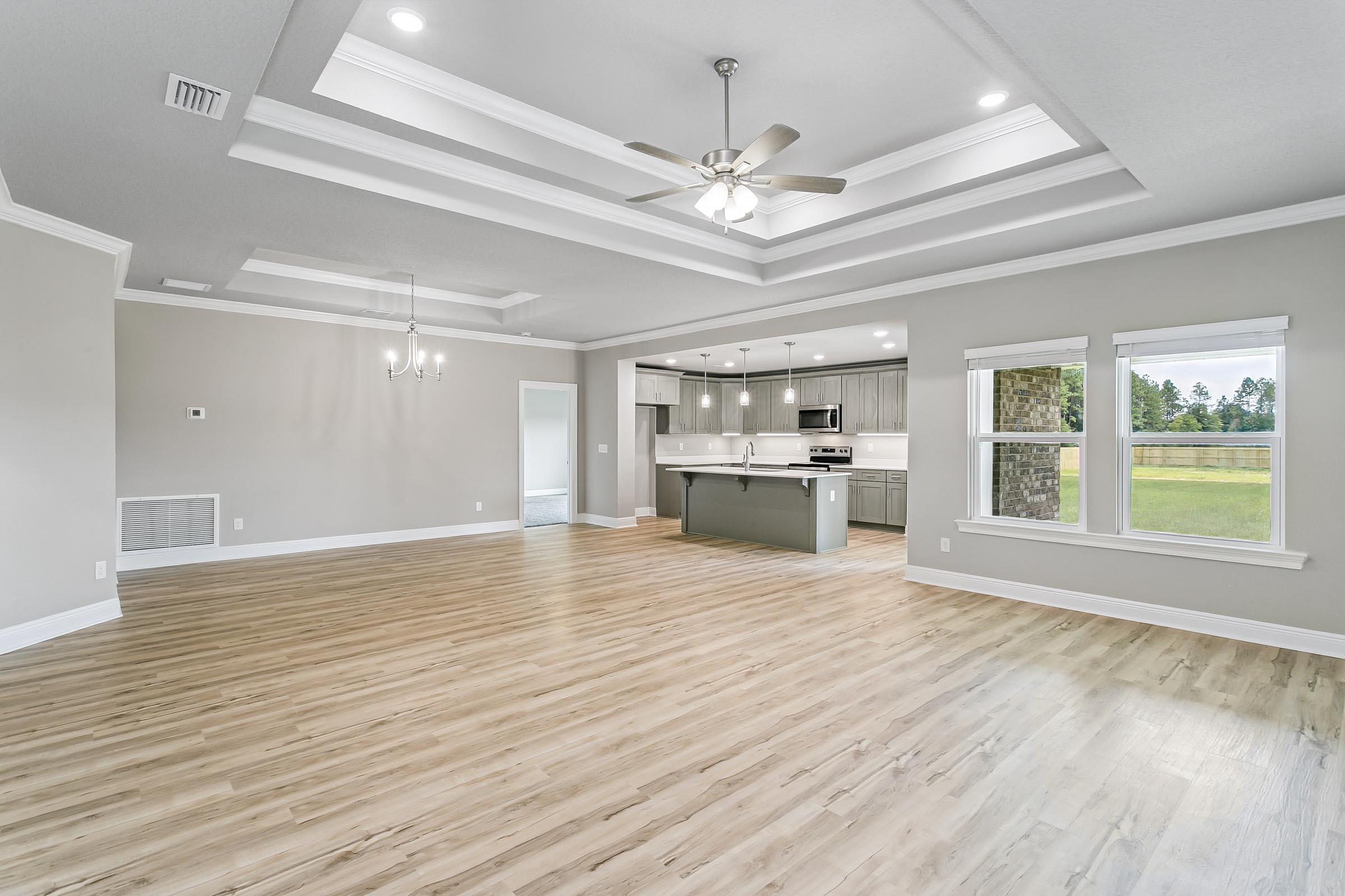 4823 Horace Lunsford Road Milton, FL 32570 - Photo 6 of 34 a view of empty room with wooden floor and fireplace