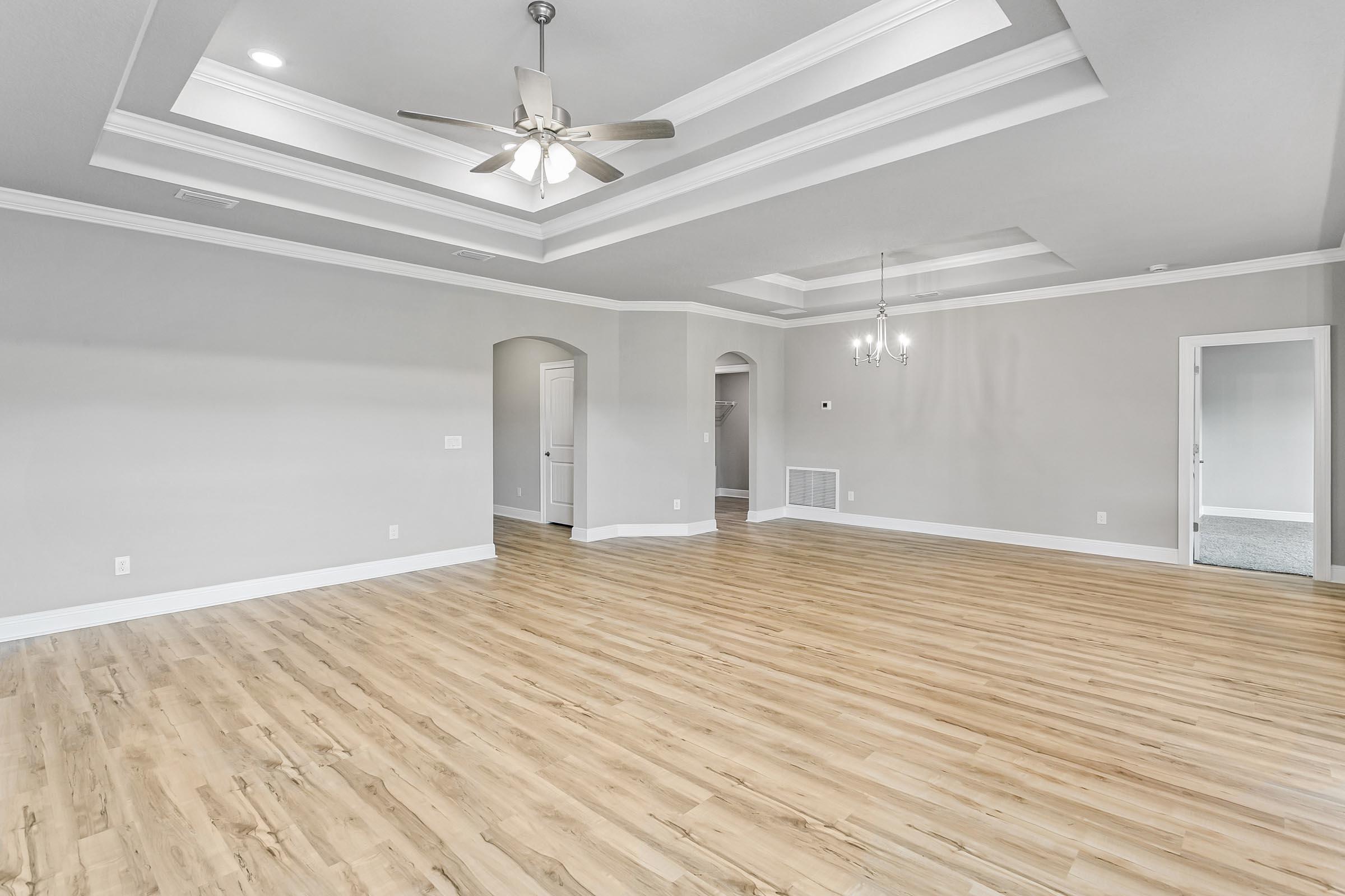 4823 Horace Lunsford Road Milton, FL 32570 - Photo 7 of 34 wooden floor in an empty room with a chandelier