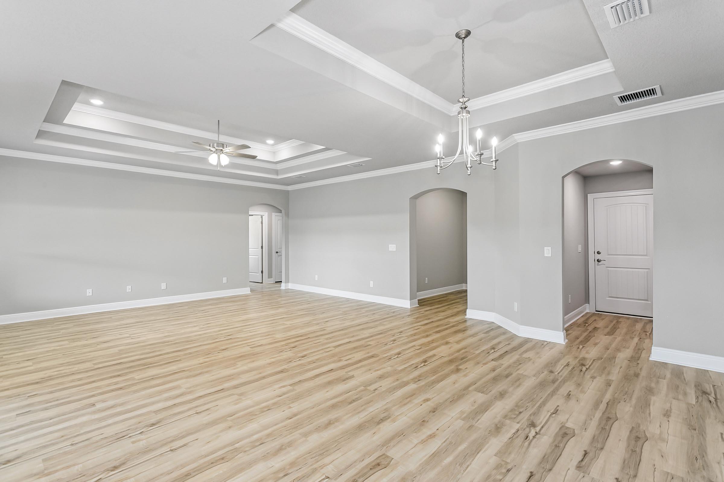 4823 Horace Lunsford Road Milton, FL 32570 - Photo 10 of 34 a view of a livingroom with a chandelier fan and wooden floor