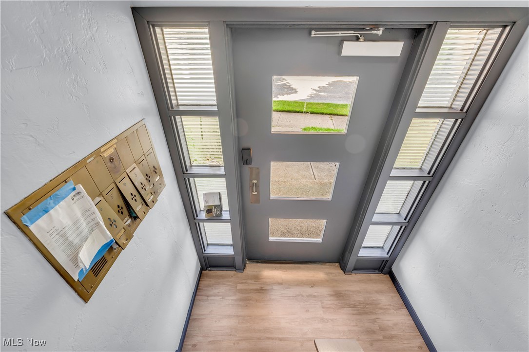5235 State Road, Unit 3 Cleveland, OH 44134 - Photo 5 of 21 Doorway to outside with light hardwood / wood-style floors and a high ceiling