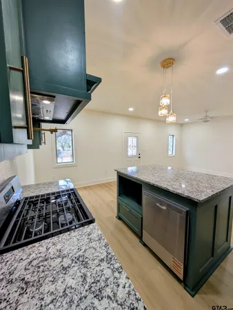 a kitchen with granite countertop stainless steel appliances and cabinets