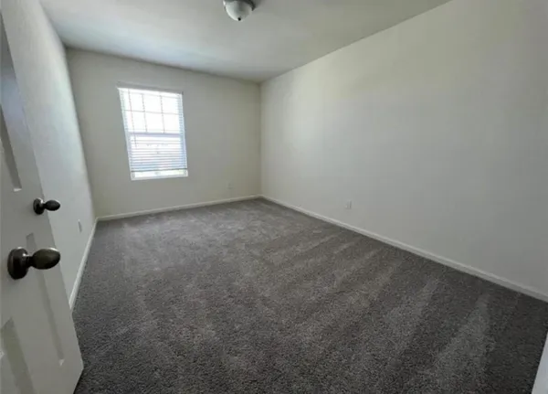 an empty room with a empty space and windows
