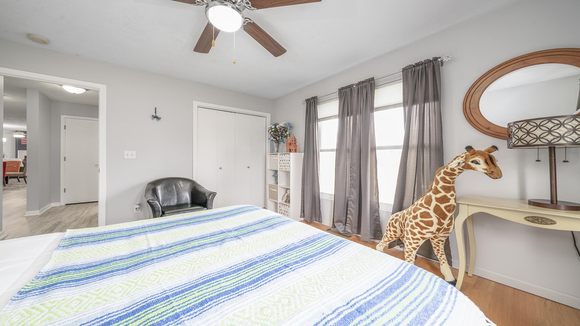 501 Pembroke Road Southwest Poplar Grove, IL 61065 - Photo 16 of 40 a bedroom with a large bed and a chandelier