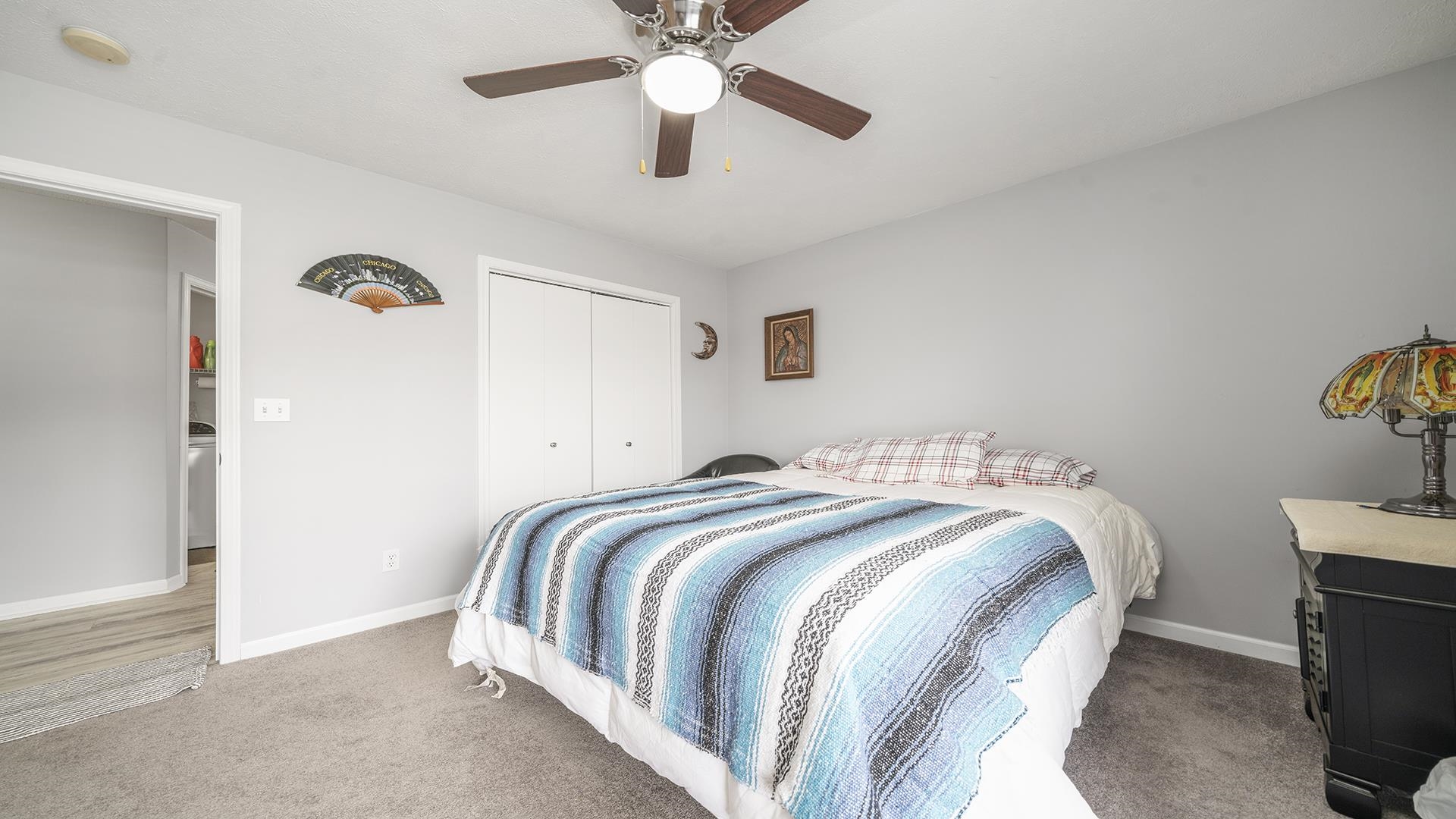 501 Pembroke Road Southwest Poplar Grove, IL 61065 - Photo 19 of 40 a bedroom with a bed and a chandelier