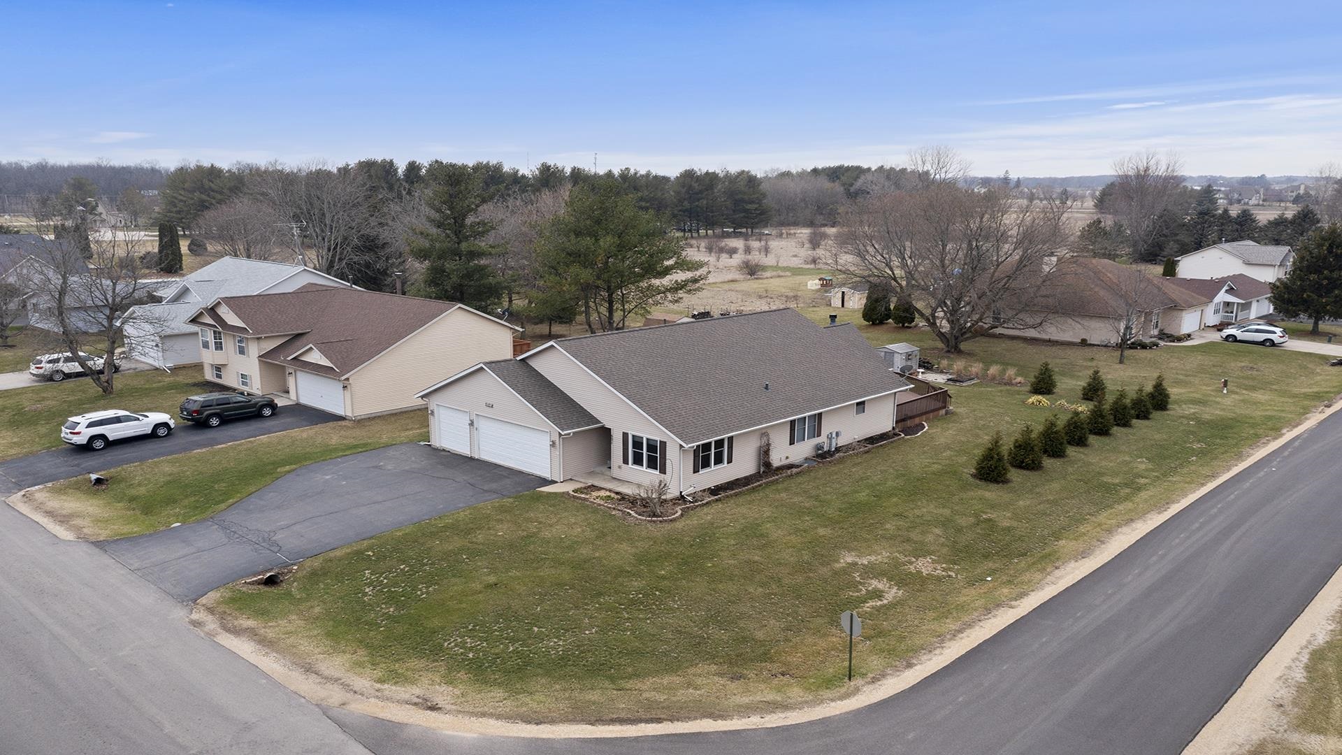 501 Pembroke Road Southwest Poplar Grove, IL 61065 - Photo 2 of 40 an aerial view of residential houses with outdoor space