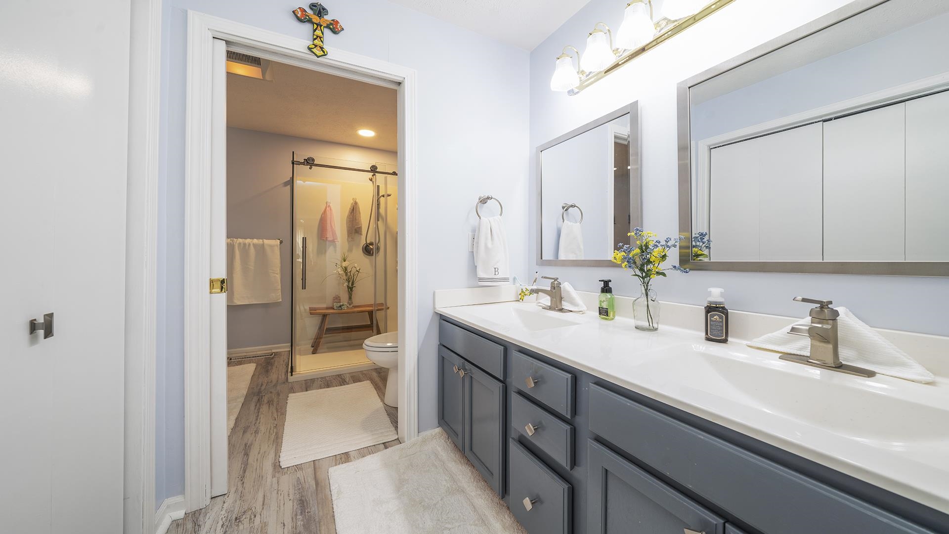 501 Pembroke Road Southwest Poplar Grove, IL 61065 - Photo 23 of 40 a en suite bathroom with a double vanity sink a mirror and a shower