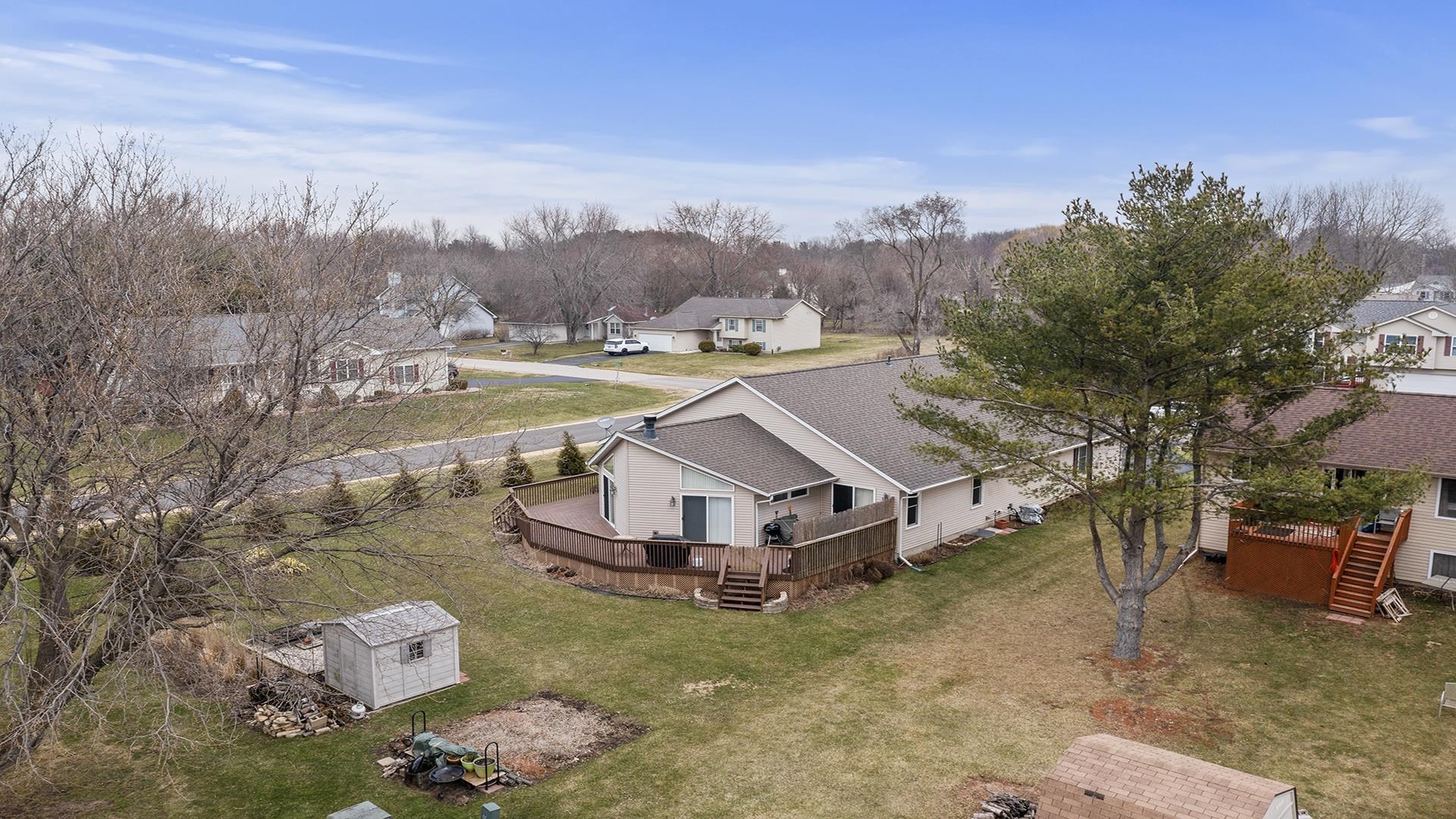 501 Pembroke Road Southwest Poplar Grove, IL 61065 - Photo 39 of 40 a aerial view of a house with a big yard and large trees