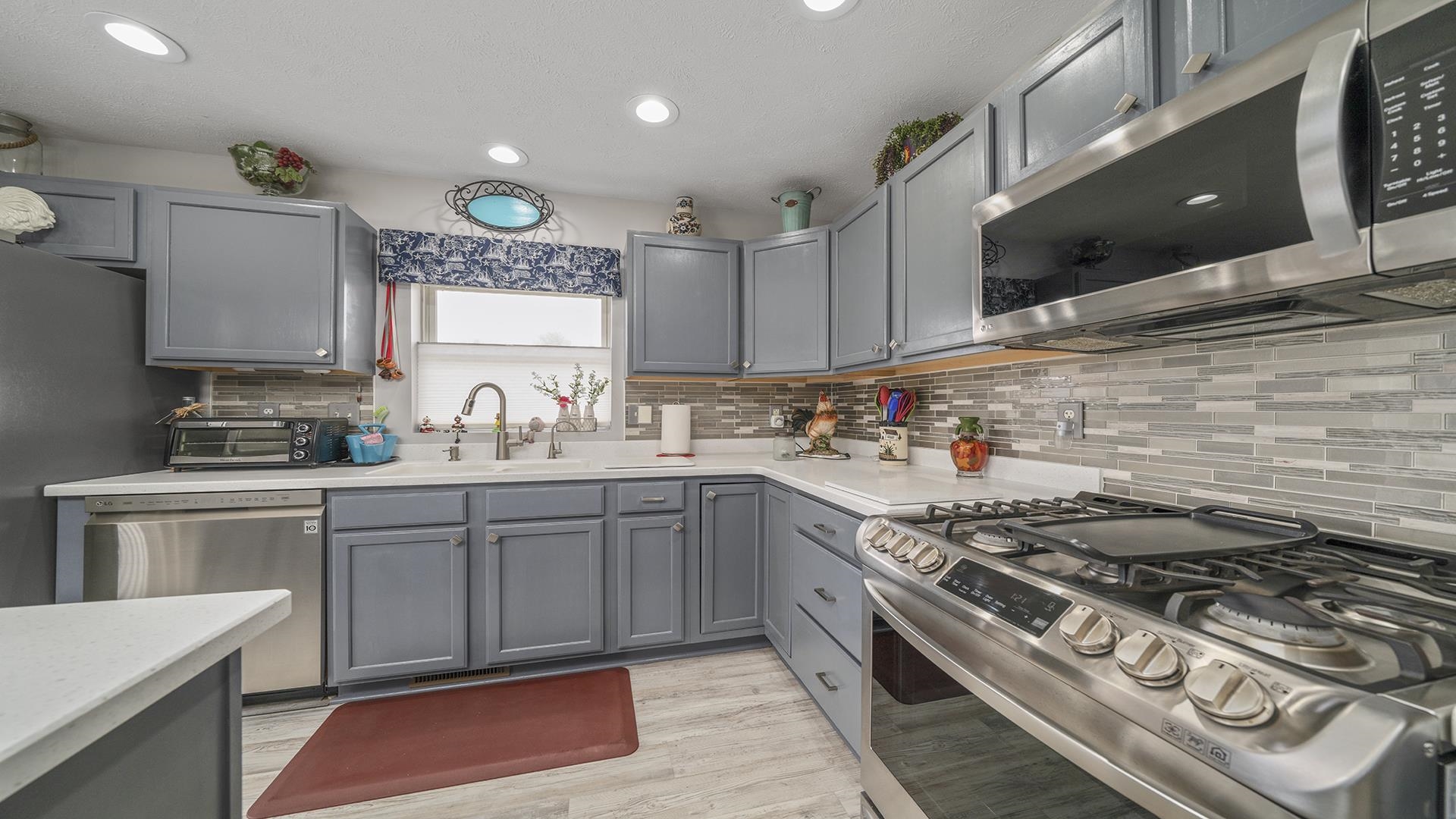 501 Pembroke Road Southwest Poplar Grove, IL 61065 - Photo 4 of 40 a kitchen with stainless steel appliances granite countertop a stove and a sink