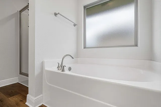 a white bath tub sitting next to a white sink
