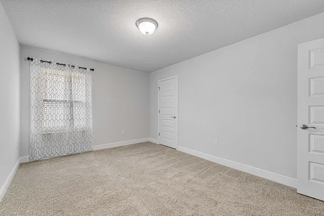 an empty room with a empty space and windows