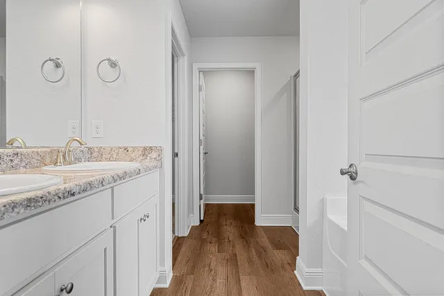 a bathroom with a granite countertop sink a toilet and shower